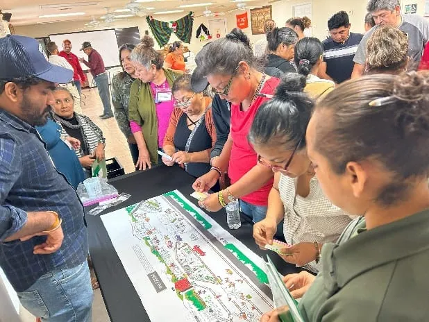 Participants working together on a large farm-map activity
