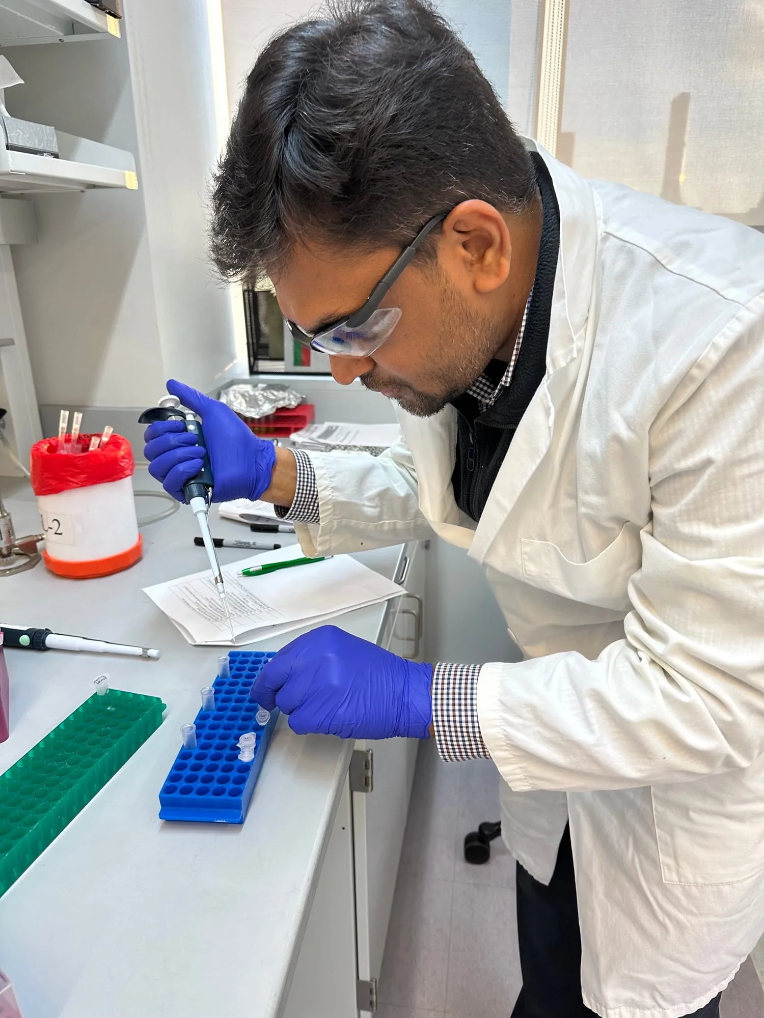 Researcher preparing samples at a lab bench